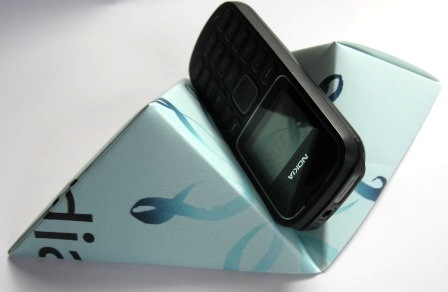 A nifty origami pattern made from Adshel poster off cuts to make mobile phone holders.